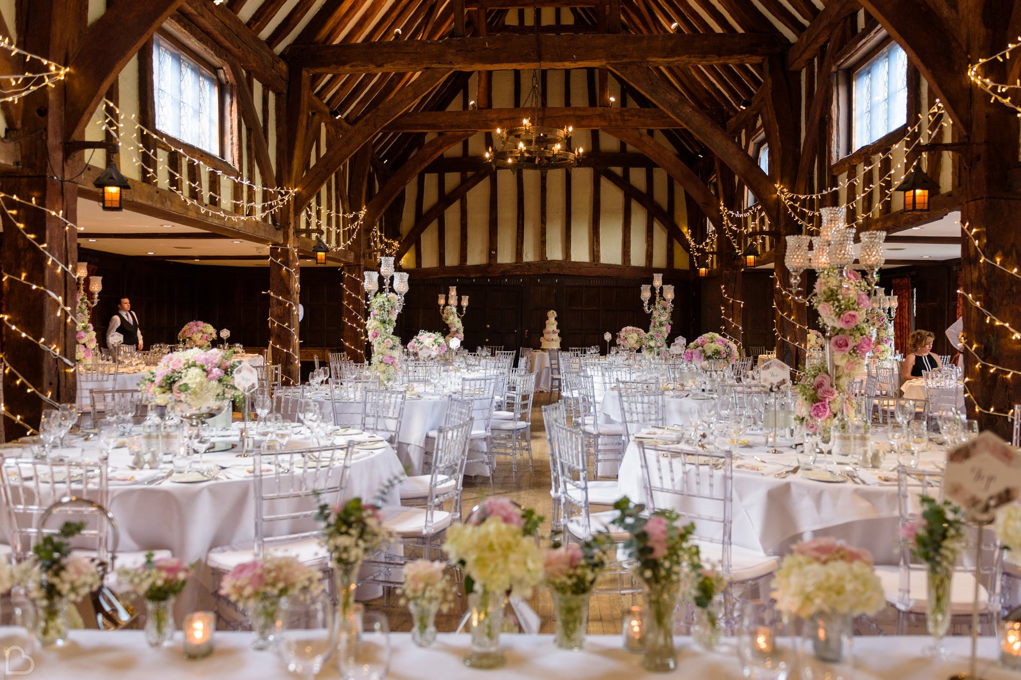 great fosters, a wedding reception venue in London, decorated with fairy lights and pastel flowers for a wedding lunch