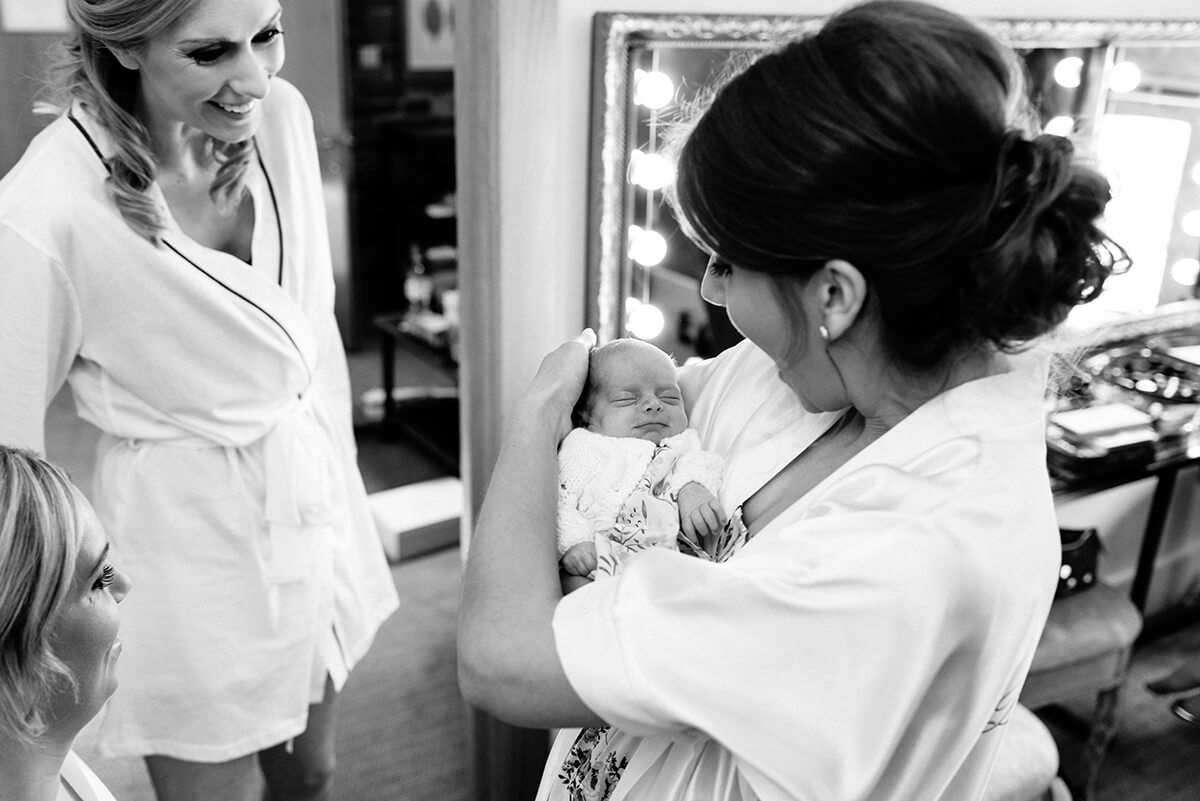 bride holds a little baby