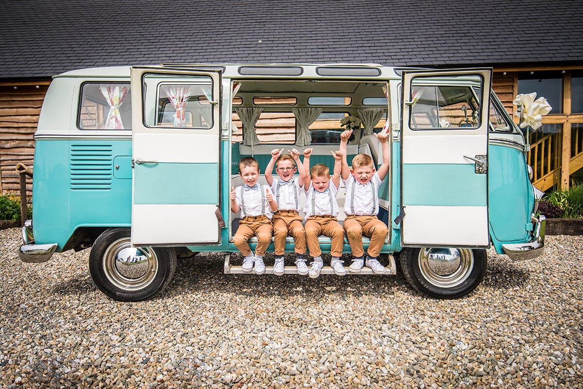 little page boys posing in a van