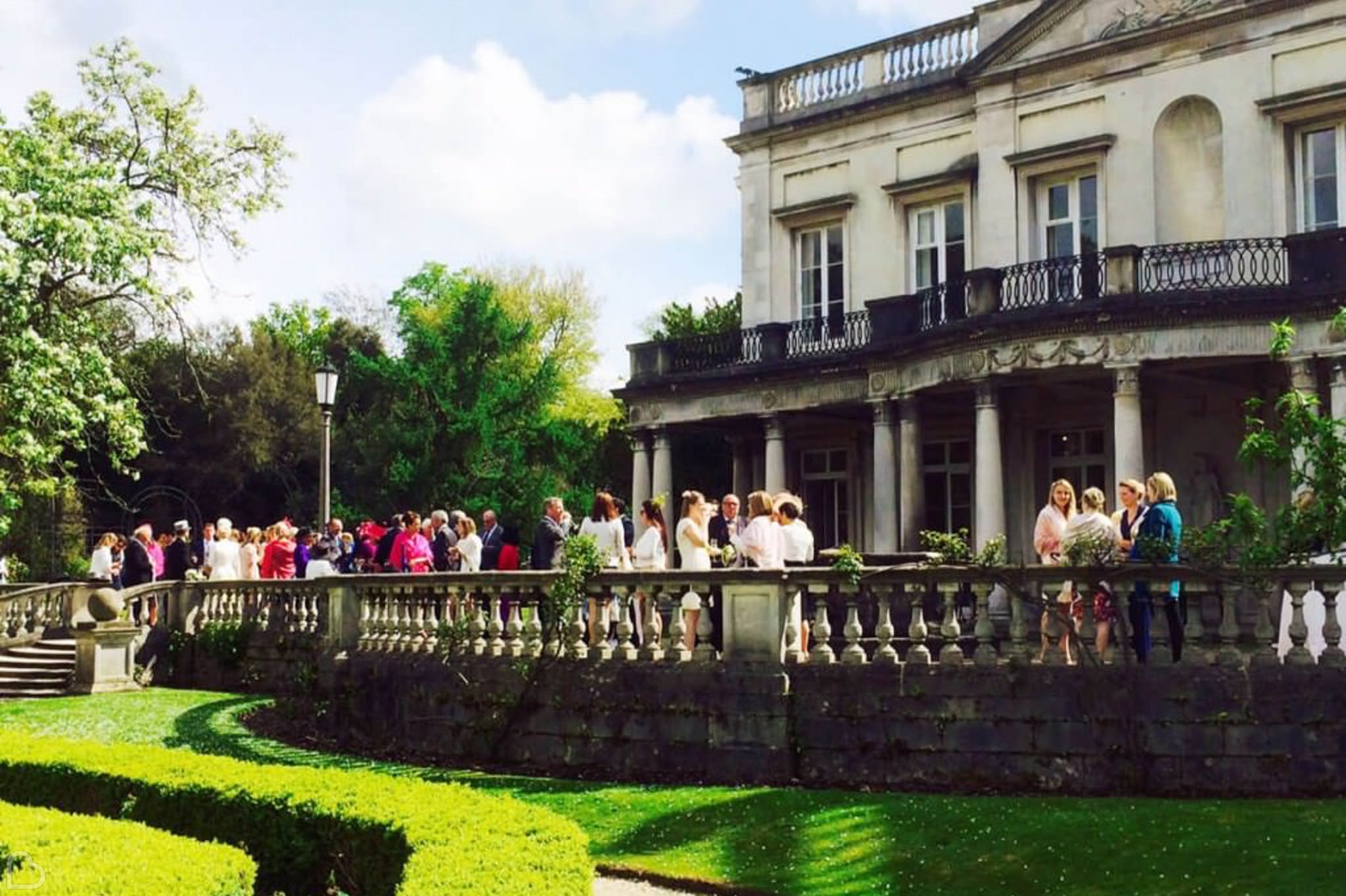 guests drink and eat on the balcony of grove house, one of the best wedding reception venues in London