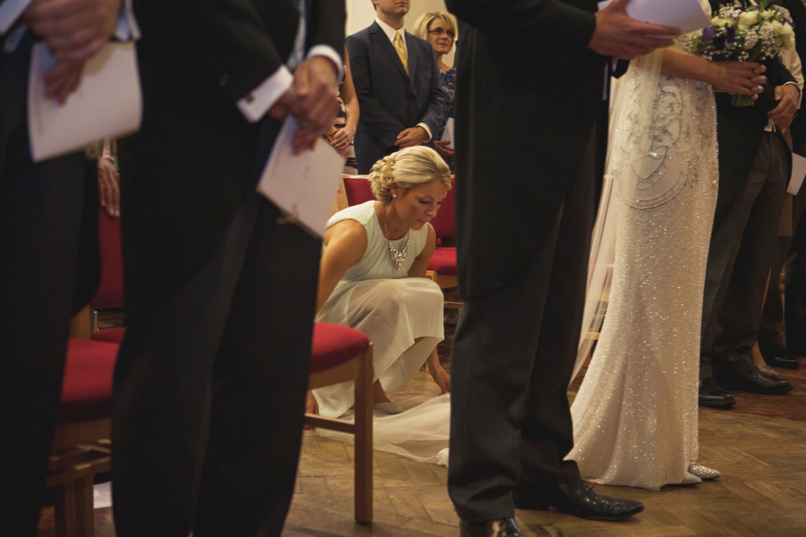 bridebook.co.uk bridesmaid fixing bride's train