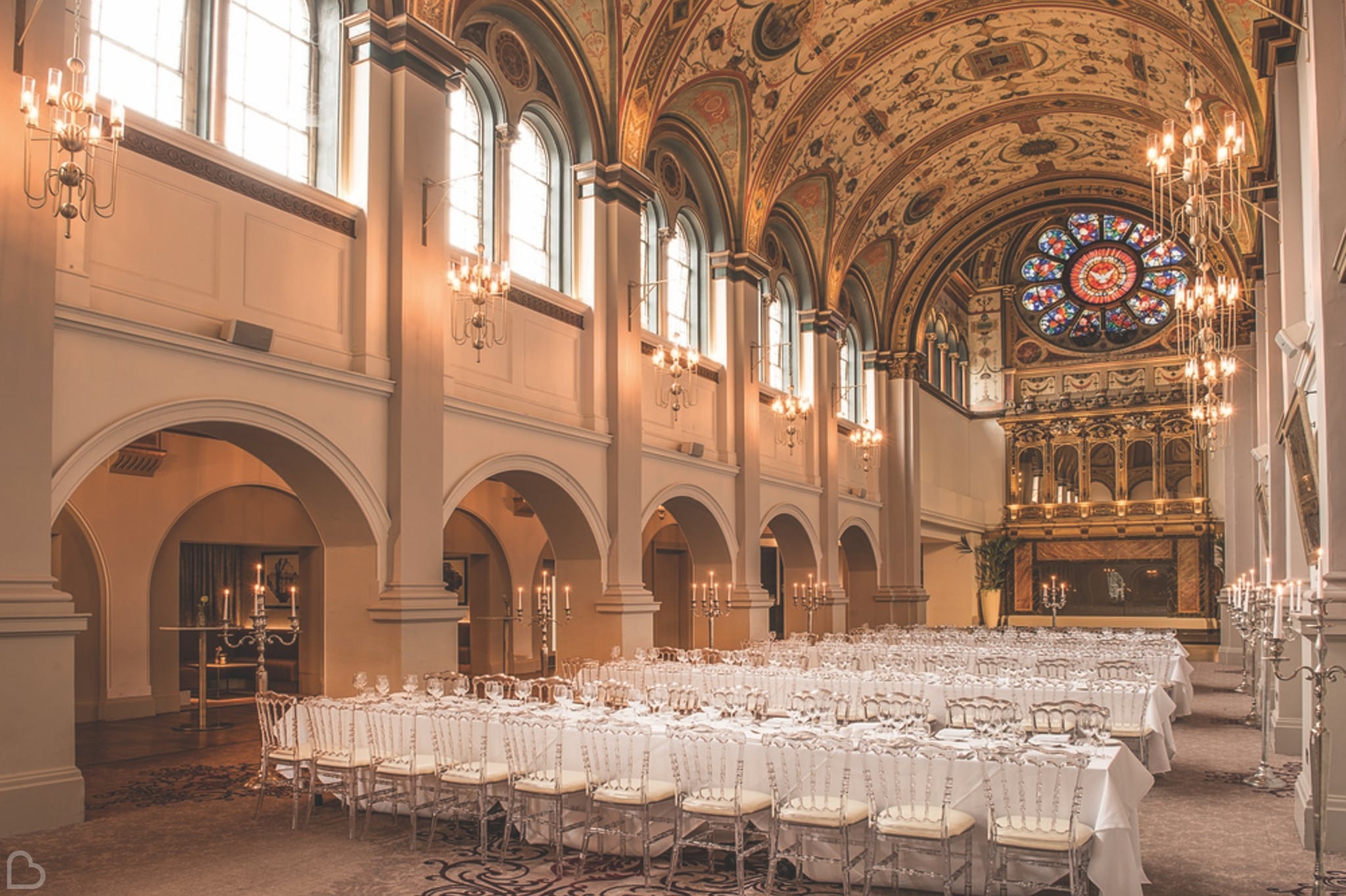 de vere windsor chapel set up for a wedding ceremony with white chairs and candles