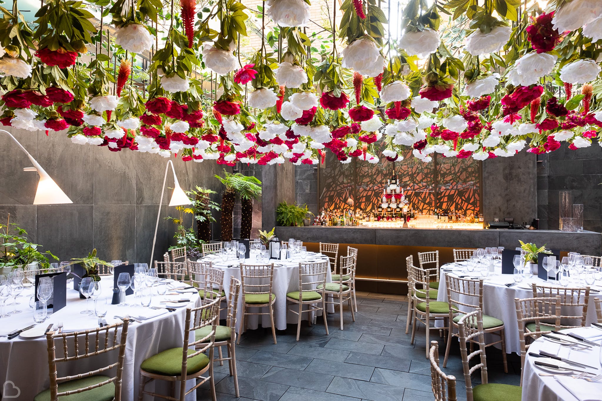 south place hotel ready for a wedding lunch with paper flowers hanging from the glass ceilling