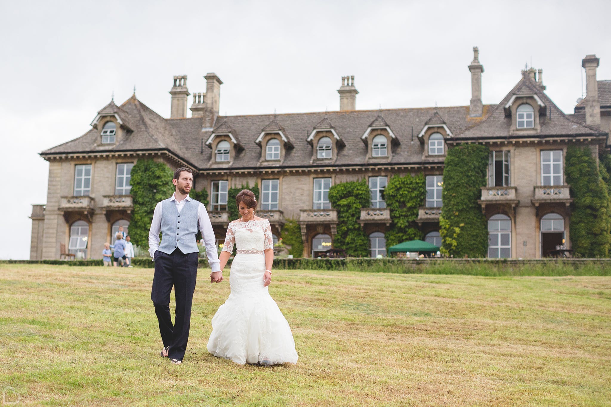 newlyweds walk holding hands outside eastwood park country wedding venue