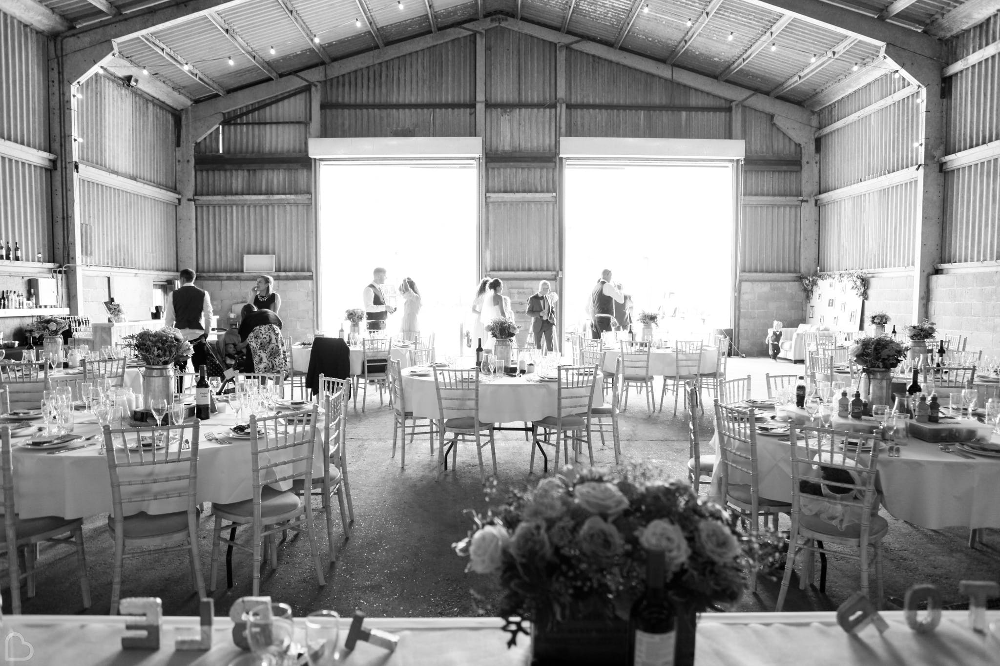 black and white photo of inside of the barns at lodge farm ready for a wedding