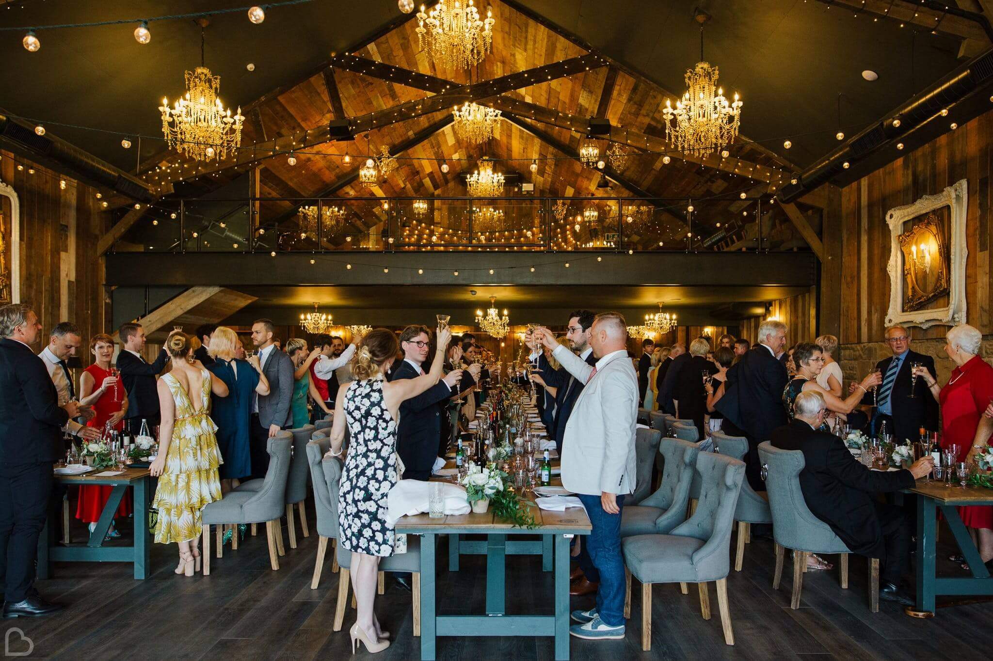 wedding guests toast inside wharfedale grange wedding venue