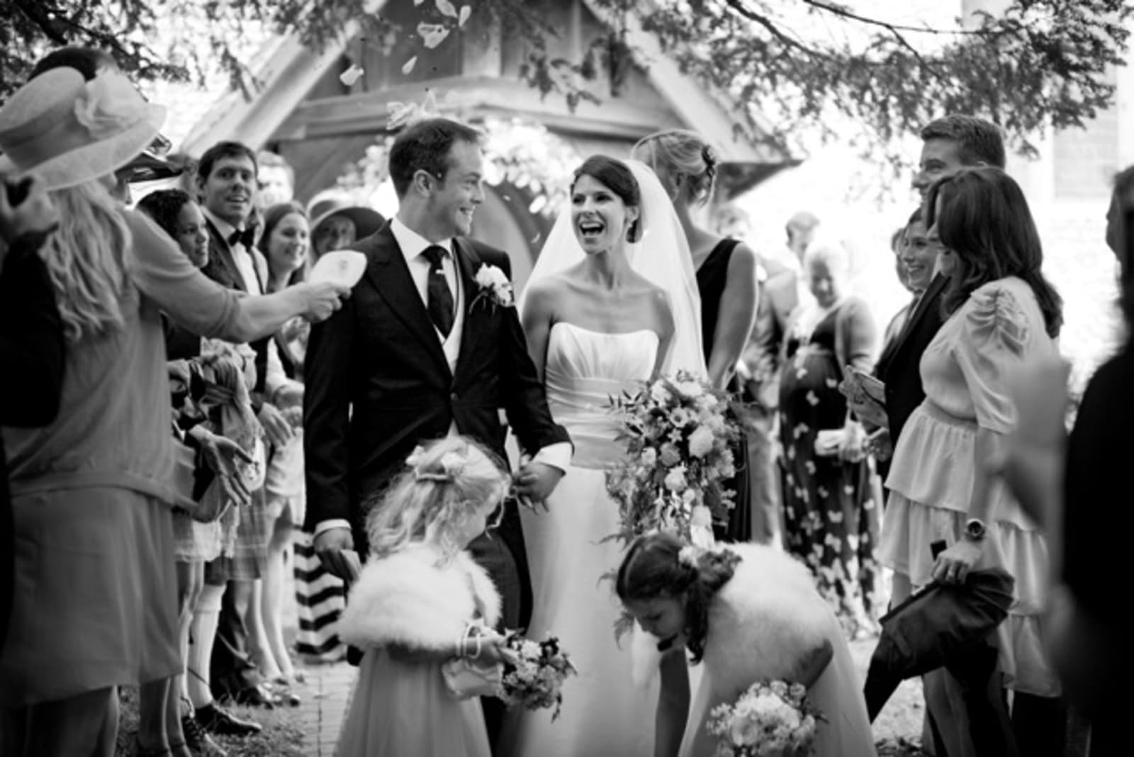 Bridebook.co.uk- bride and groom walking out of the church just married