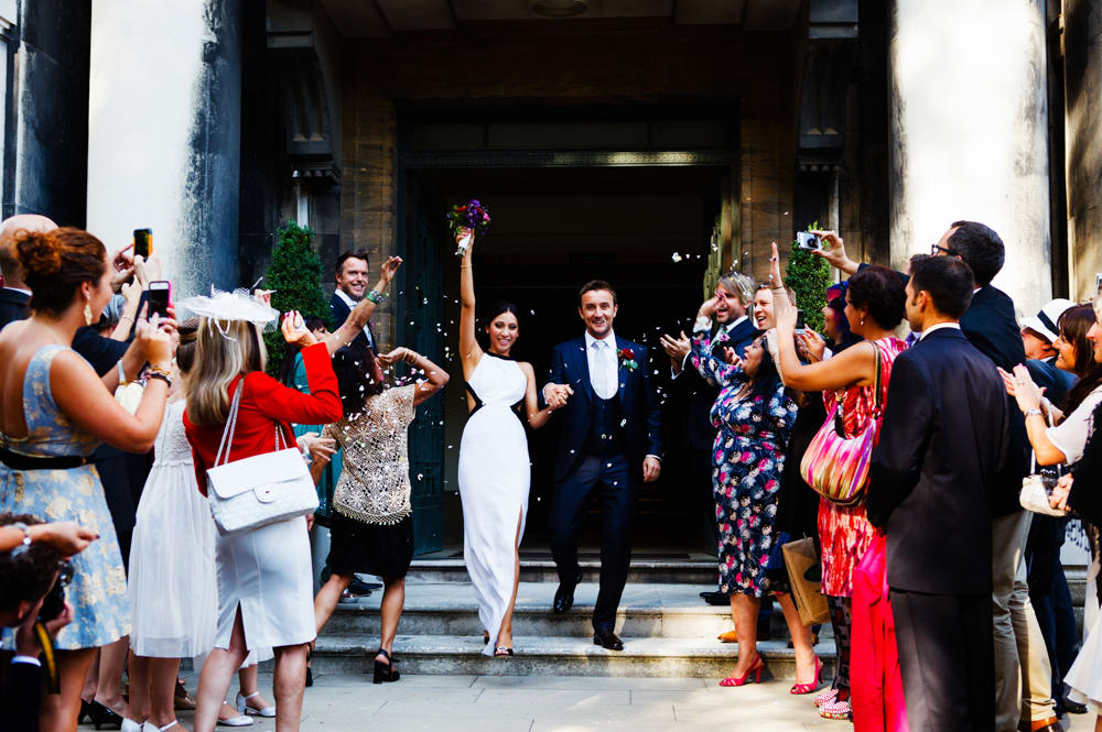 bridebook.co.uk brides and groom showered in confetti