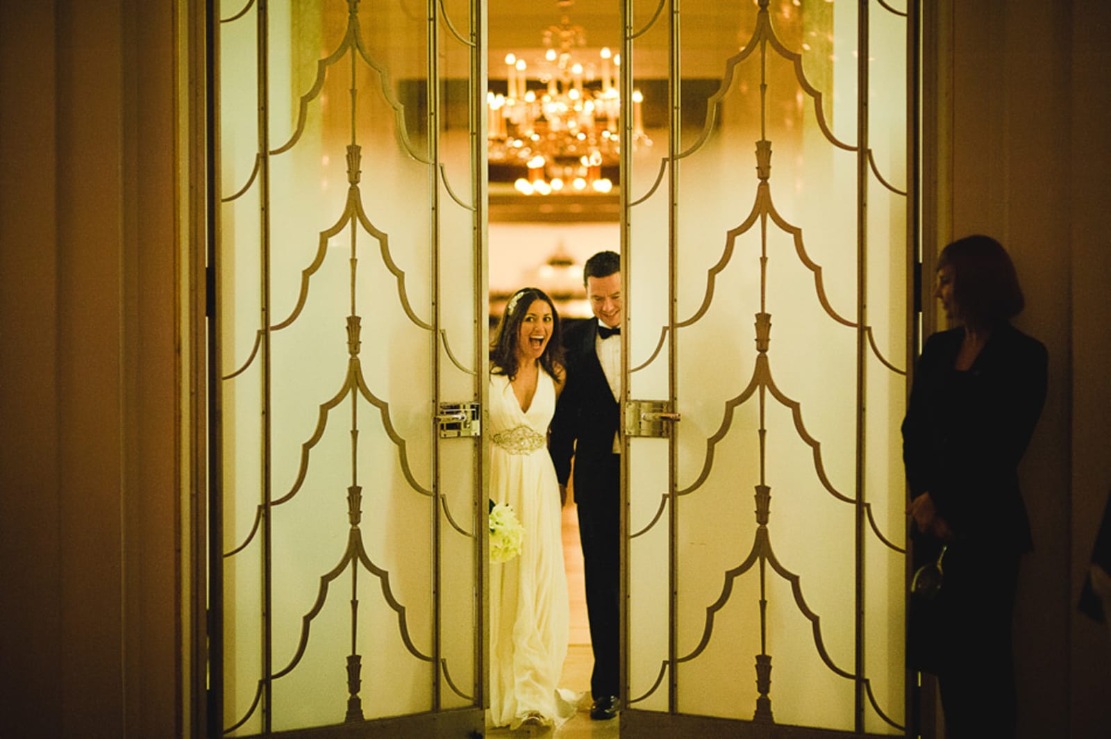 Bridebook.co.uk- bride and groom walking into reception