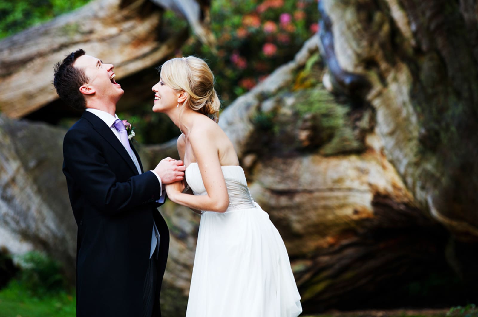 Bridebook.co.uk- bride and groom holding hands and laughing