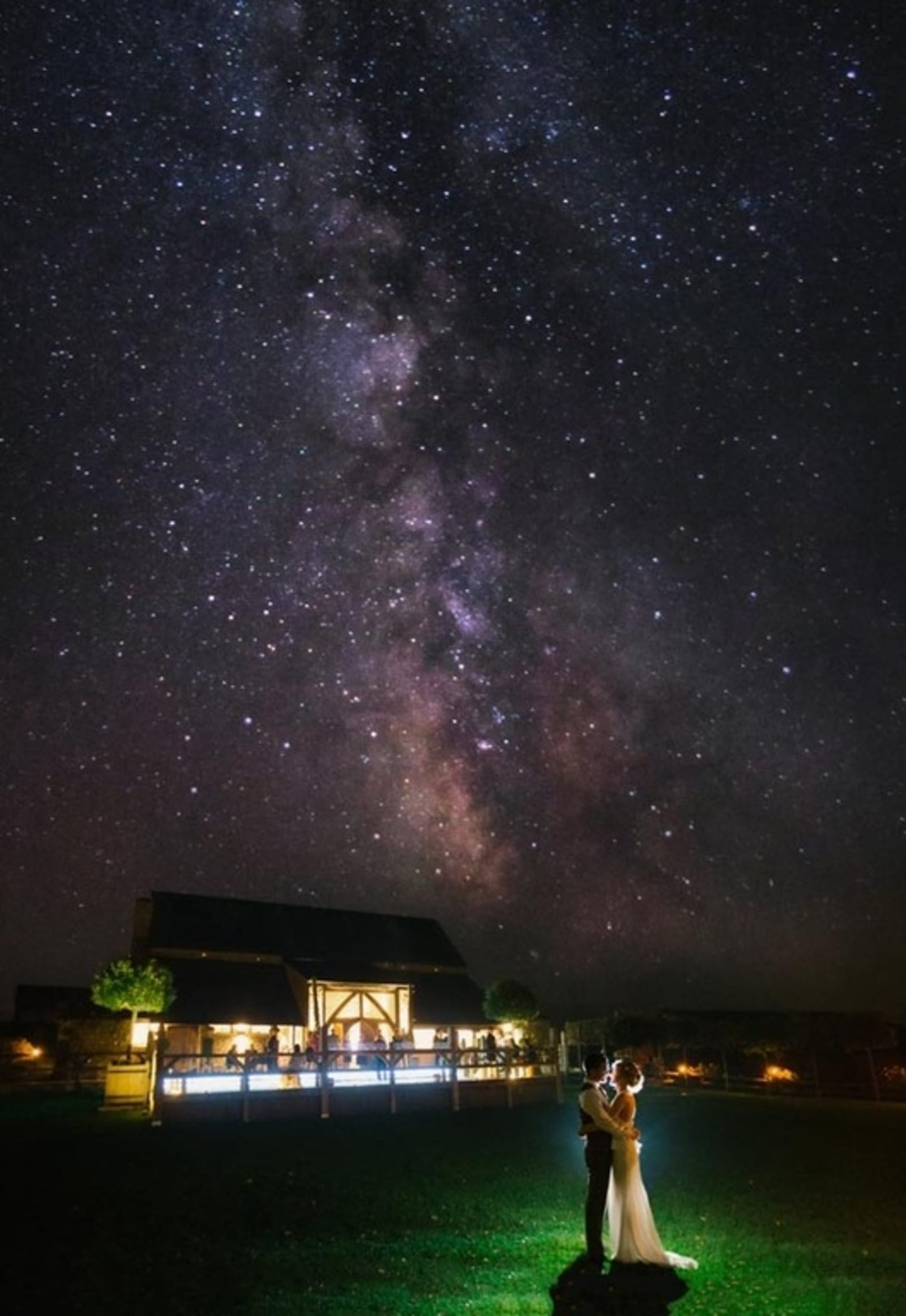 Bridebook.co.uk- bride and groom in front of the venue and starry sky