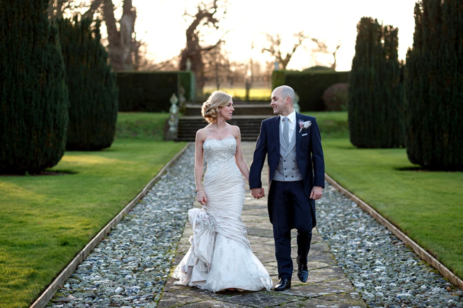 Bridebook.co.uk- bride and groom holding hands and walking