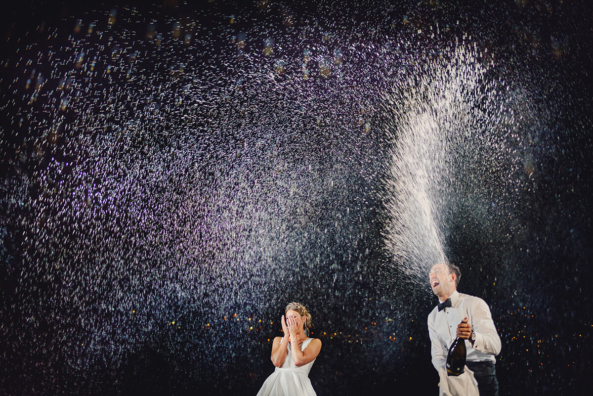 newlyweds pop the champagne