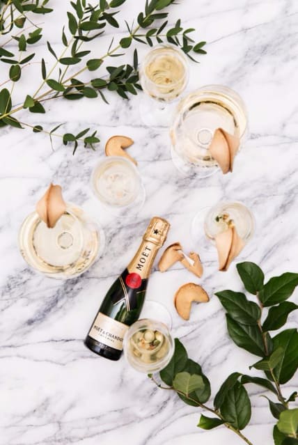 Bridebook.co.uk moet champagne on marble with leaves