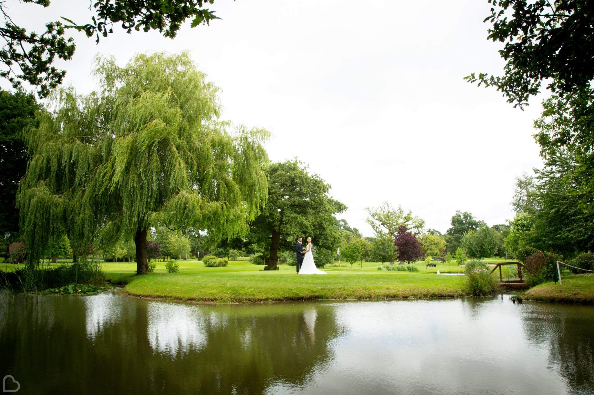 nailcote hall hotel a couple walks outside next to the lake