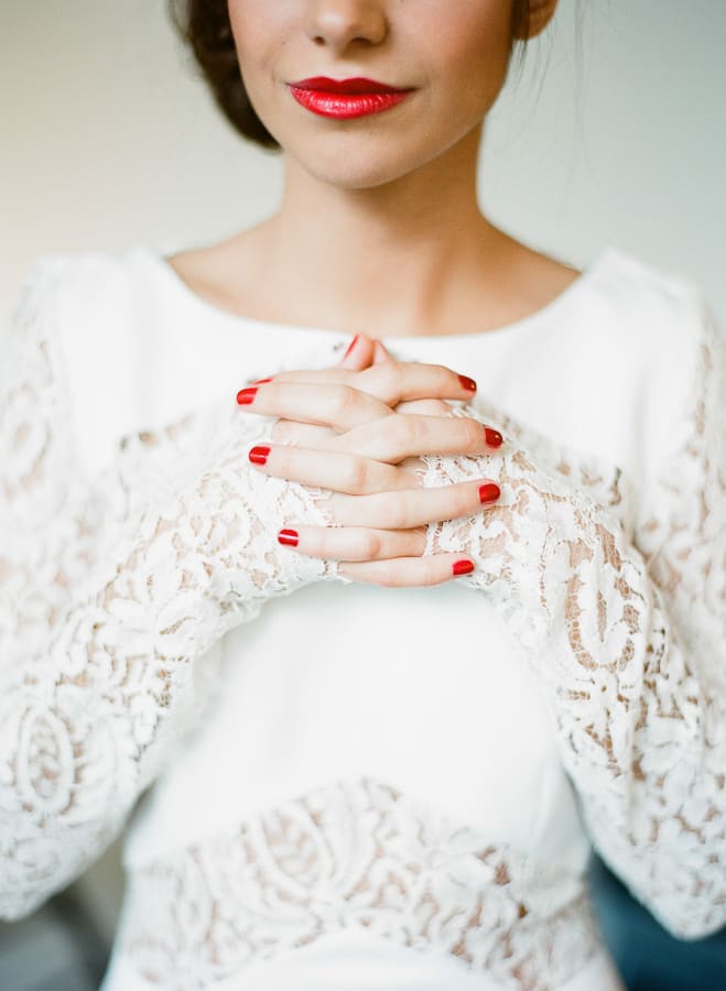 bridebook.co.uk bride in white with red lips and nails