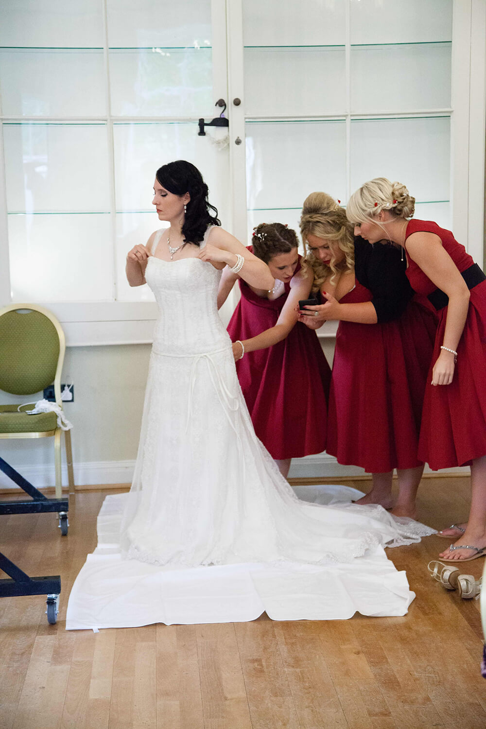 Bridebook.co.uk Bridesmaids taking photo of dress