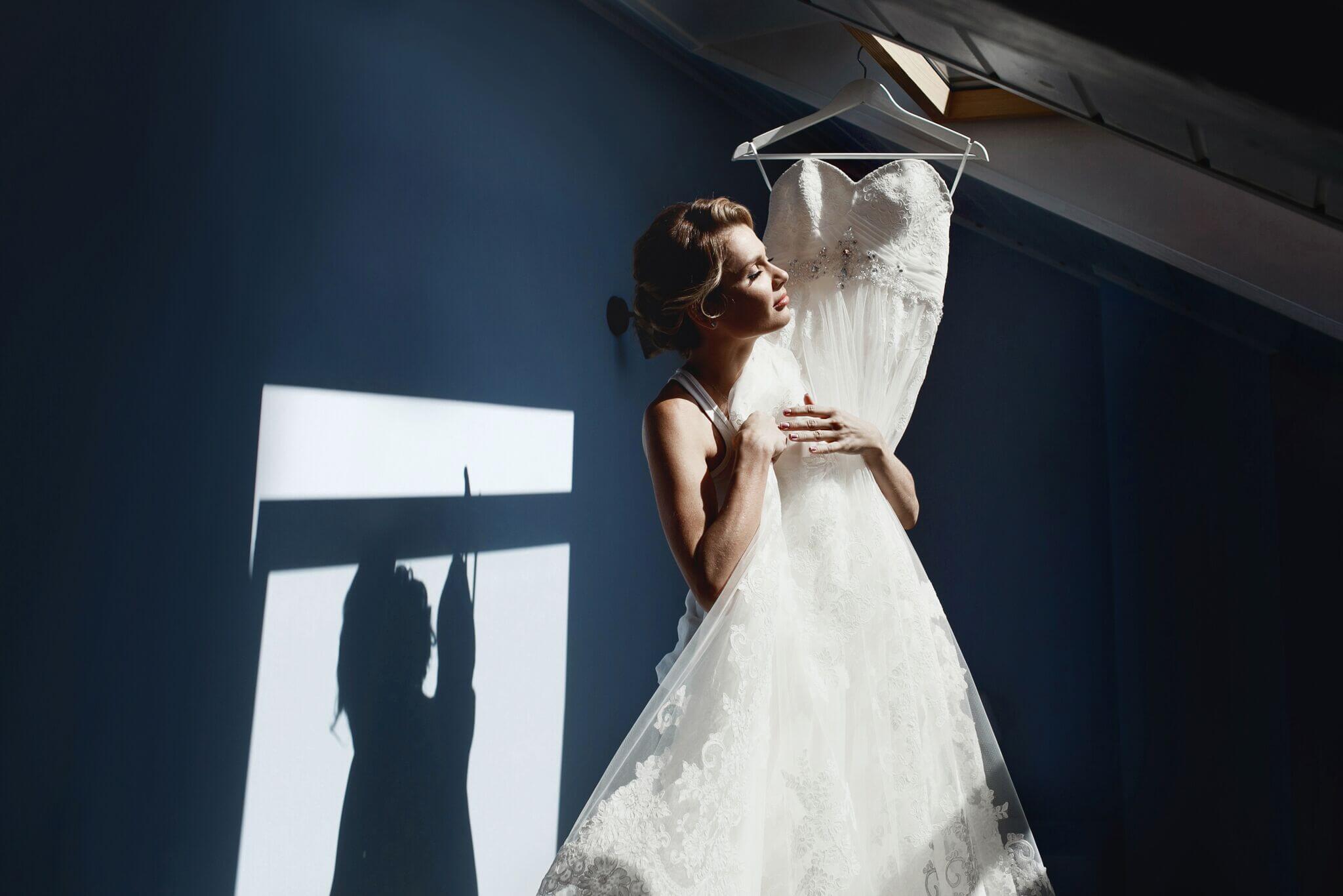 Bridebook.co.uk Woman Holding Wedding Dress 