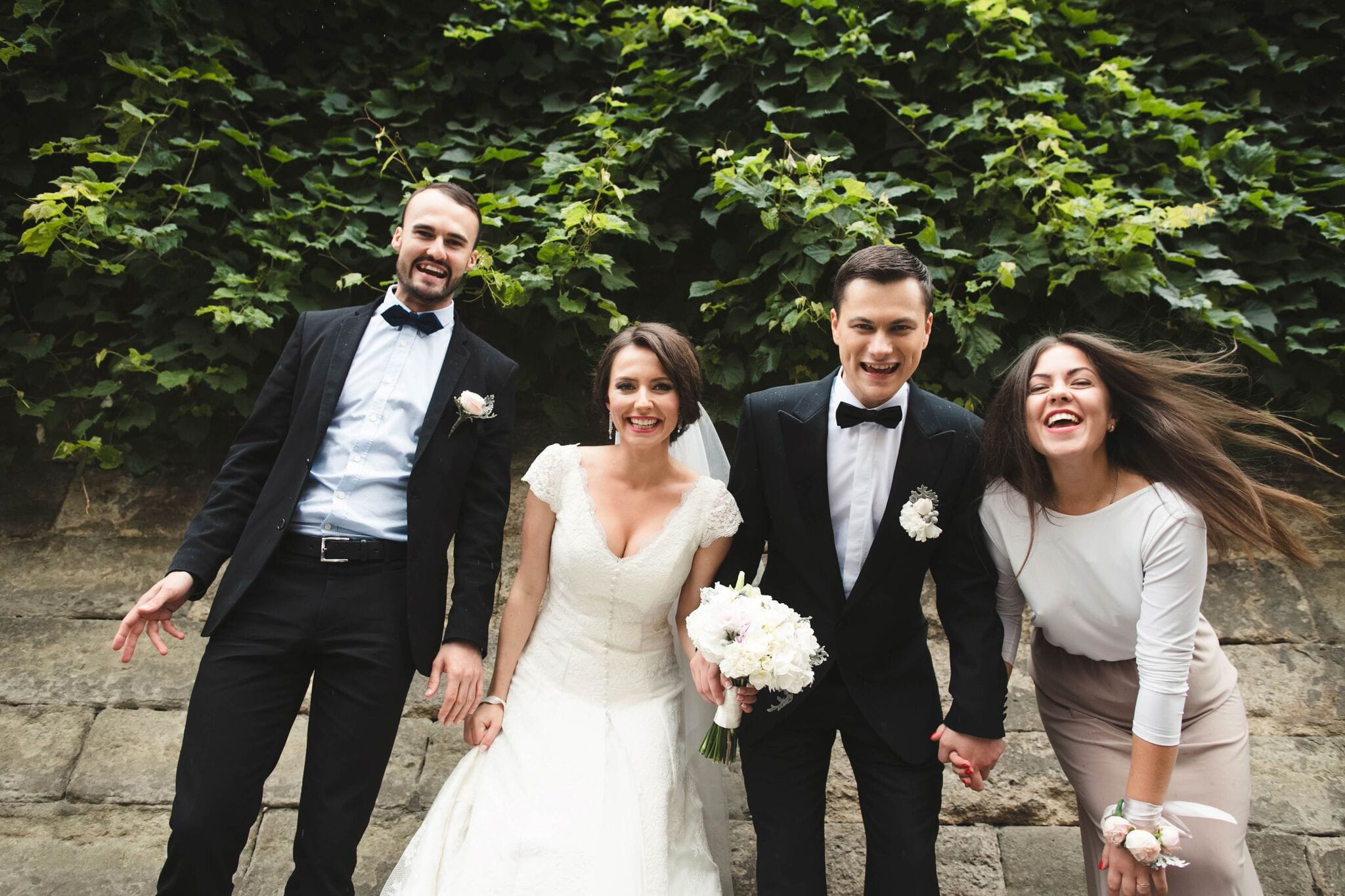 Bridebook.co.uk BRide and groom laughing with guests